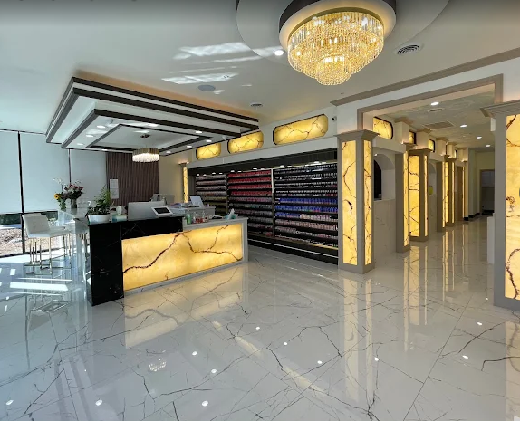 Reception desk with backlit stone and retail polish wall